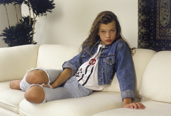 milla jovovich, young girl, long hair, eyes, jeans, vest, jacket, sofa, beauty, young, sexy babe, brunette, model, posing, sitting, sofa, celebrity, personality, actress, hollywood, real celebs wall