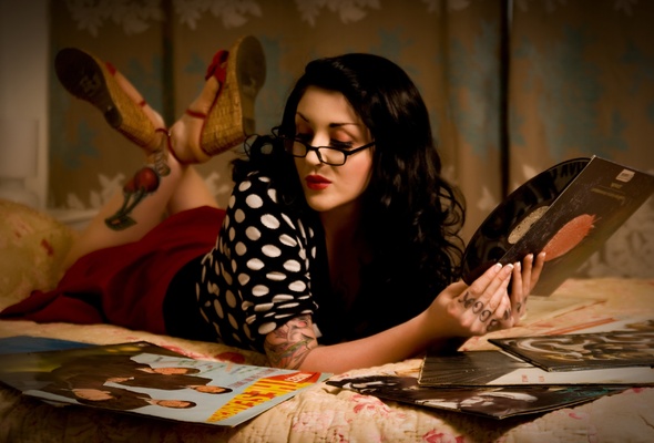 young, brunette, alternative, amateur, model, slim, sexy babe, long hair, laying, bed, sexy, dressed, retro, pin up style, close up, eyes, face, glasses, sexy, red lips, lift legs, tattoo, pin up