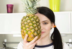 betty, black hair, teen, green eyes, cute, pineapple, kitchen, face, smile, someones getting the rough end of the pineapple