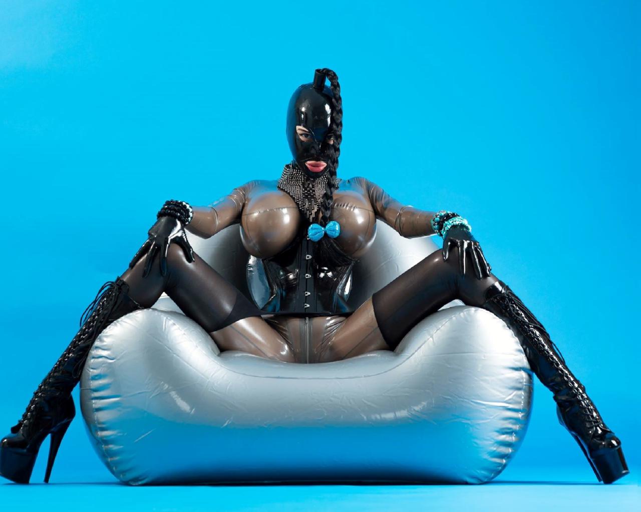 ariane saint, canadian, redhead, adult model, busty, sexy babe, tattoo, fetish model, posing, sitting, inflatable, pvc, chair, tight clothes, latex, catsuit, fullsuit, hood, mask, underbust corset, stockings, gloves, rubberdoll, fetish babe, ariane saint amour, black, knee boots, shiny, rubber, fetish, babes in boots, dressed for sex, plateau boots