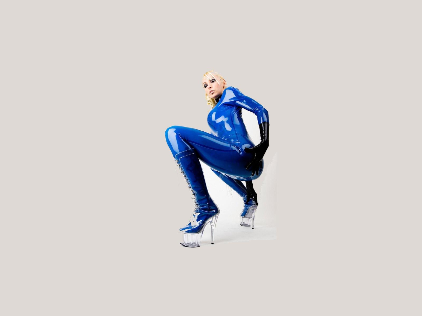 latex, blonde, sexy, heels, minimalist wall, susan wayland, blue, catsuit, fullsuit, gloves, shiny, rubber, fetish, plastic, plateau boots, tight clothes