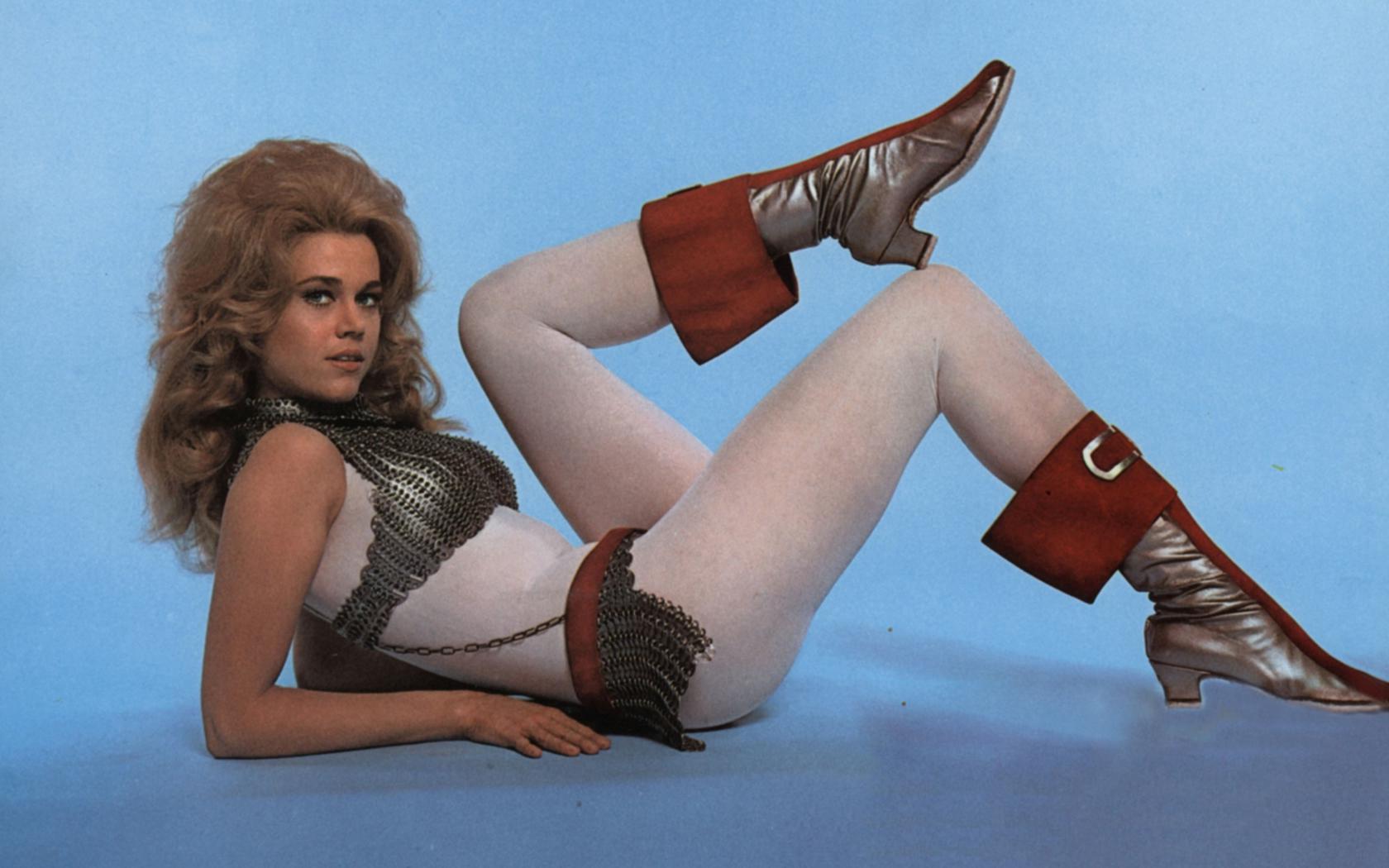 jane fonda, blonde, american, actress, sex symbol, glamour, movie, hollywood, barbarella, posing, laying, tight clothes, white, catsuit, metal, bra, shiny, boots, erotic, retro, fetish babe, jane, jane seymour fonda, real celebs wall